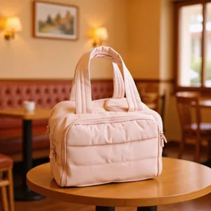 Pink puffer cosmetic bag, large capacity travel makeup organizer for daily portable use.