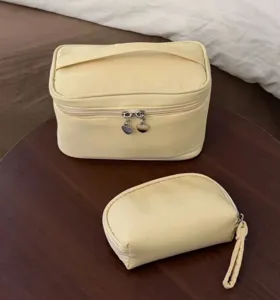 Detailed view of yellow cosmetic bag set, large capacity portable makeup storage pouch organizer.