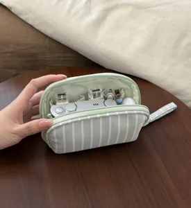 Close-up of the interior compartments and striped design of the portable cosmetic storage pouch.