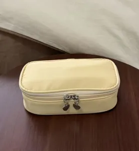 Yellow cosmetic bag for women, large capacity portable travel makeup storage pouch with zippers.