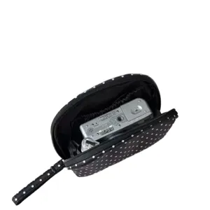 Classic black and white polka dot cosmetic bag with a handy wrist strap for easy travel storage.