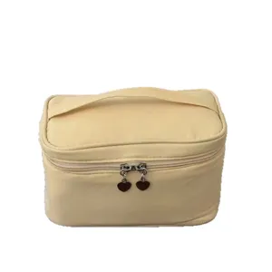 Portable yellow cosmetic bag with large capacity, durable fabric and cute heart zipper pulls.