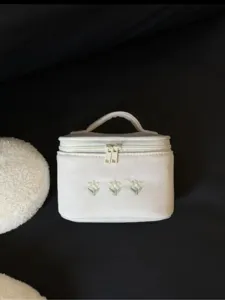 Floral cosmetic bag for women, portable travel makeup storage pouch with handle and zipper.