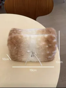Cute plush cosmetic bag detail, soft fawn pattern fur with ribbon bow and deer charm.