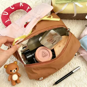 Large capacity dopamine cosmetic bag with cute puffer handle for travel and daily storage.