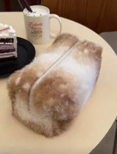 Detailed view of the cute plush cosmetic bag showing soft furry texture and center zipper.