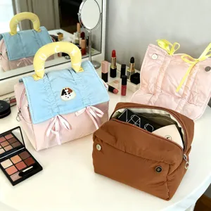 Details of the cute cartoon travel cosmetic bag with large capacity, colorful design and handle.