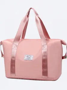Large capacity pink travel duffel bag for women, portable luggage and weekend overnight bag.