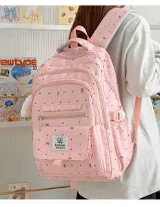 Zaino rosa per studenti con grazioso motivo a fiocco, grande capacità e tasche multiple.