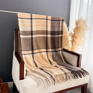Detail view of a cozy vintage plaid cashmere-feel shawl scarf with stylish fringe edges.