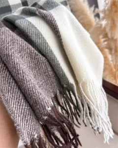 Detail view of winter warm retro plaid imitation cashmere scarf with soft tassel fringe texture.