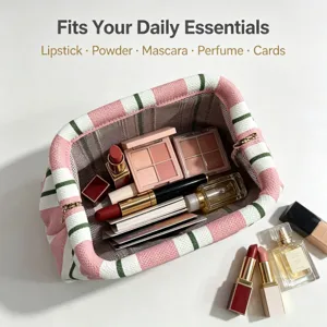Knit striped cosmetic bag with metal frame clasp, perfect for daily makeup essentials.
