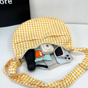 Yellow plaid crescent shoulder bag for women, stylish hobo crossbody bag with large capacity.