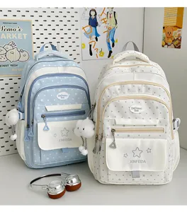 Detail shot of cute polka dot school backpack with star patterns and lovely cloud pendant decoration.