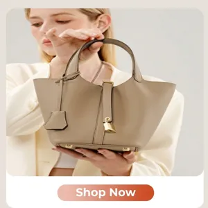 Elegant leather bucket handbag for women, chic shoulder bag with top handle and lock design.
