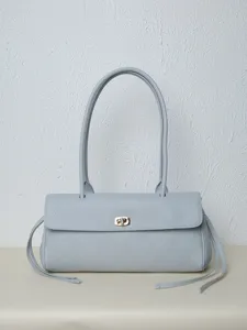 Detailed view of the light blue leather shoulder bag with chic quilted design and lock.