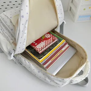Casual student backpack with star dot pattern, spacious interior for books and laptop.