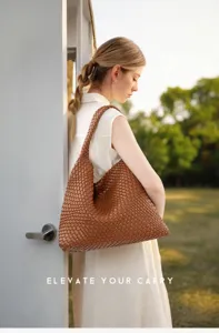 Detailed view of the stylish woven leather hobo shoulder bag worn by model outdoors.