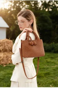 Brown woven leather handbag for women, casual chic shoulder bag with stylish knot detail.