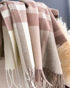 Detailed view of soft vintage plaid cashmere feel winter scarf with elegant fringe design.