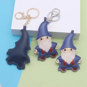 Close-up detail of cute leather gnome keychain featuring fine stitching and metal hardware.