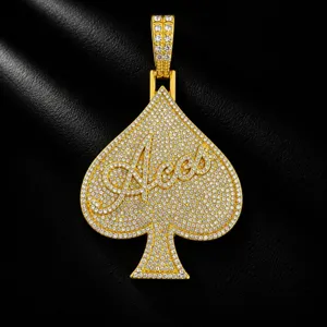 Detailed shot of a gold iced out spade Aces pendant, sparkling hip hop men necklace jewelry.