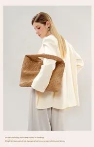 Detail shot of the brown woven leather shoulder tote bag, showcasing handmade texture and craftsmanship.