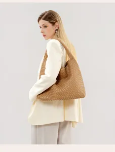 Woven shoulder bag detailed view, showcasing premium leather texture and elegant slouchy design.