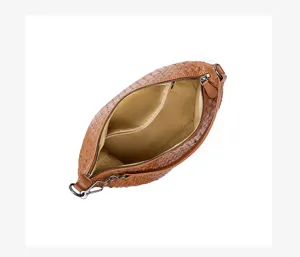 Detailed top view of brown woven leather underarm handbag showcasing interior lining and quality.