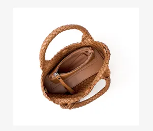 Top-down view of brown woven leather handbag showing detailed braided texture and inner pouch.