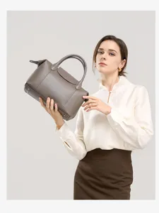 Grey genuine leather top-handle shoulder bag detail shot, showcasing fine texture and flap design.