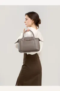 Taupe genuine leather pillow handbag for women, spacious shoulder bag for chic daily wear.