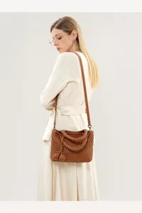 Detailed view of the brown woven leather shoulder bag showing exquisite craftsmanship.