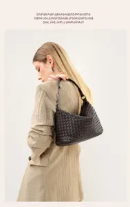 Detailed view of brown woven leather shoulder bag, stylish underarm design and smooth texture.