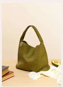 Detailed view of the olive green woven leather shoulder bag, showcasing exquisite craftsmanship.