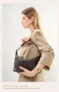 Close-up detail of the dark brown woven leather shoulder handbag with exquisite texture.