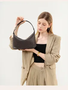 Detailed view of dark brown woven leather underarm handbag highlighting exquisite craftsmanship.