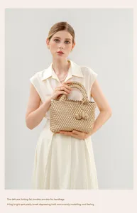 Elegant metallic gold woven handbag with knotted handle detail, chic premium style for women.