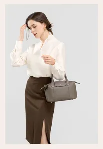 Elegant genuine cowhide leather handbag detail showcase, chic shoulder crossbody design for women.