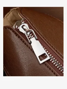 Close-up detail of the brown genuine leather handbag featuring a polished silver metal zipper.