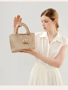Metallic gold woven leather handbag with elegant knot details, chic minimalist tote bag.