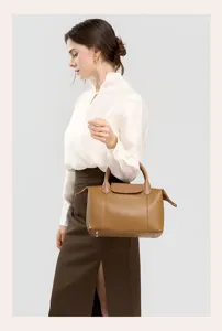 Elegant brown leather top handle bag for women, spacious tote with classic flap design for daily use.