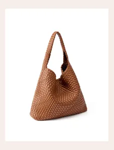 Detailed close-up showing exquisite woven leather craftsmanship and smooth texture of the brown hobo bag.