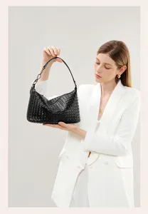 Detailed view of the black woven leather shoulder bag showcasing artisan craftsmanship.