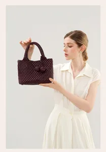 Handmade woven leather handbag for women, chic commuting tote bag with braided handle.