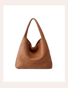 Detailed close-up of brown woven leather hobo shoulder bag, showing handcrafted texture.