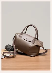 Stylish genuine leather pillow bag, top handle shoulder crossbody tote for women. Chic design.