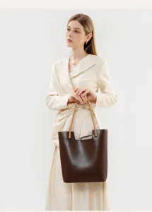 Detailed view of women's leather tote bag in dark brown with stylish dual handles.