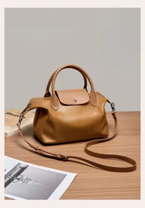 Brown leather top handle shoulder bag with flap closure and stylish daily design for women.