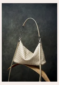 Elegant genuine leather woven shoulder bag detail showcasing exquisite craftsmanship and style.